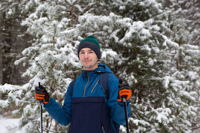 Portrait of smiling boy standing on snow