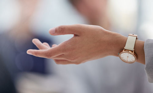 Cropped hand of woman holding wedding rings