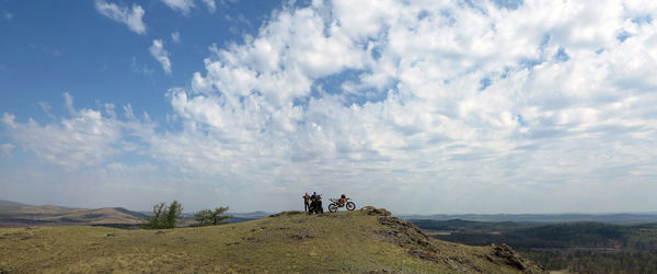 Panoramic view of people on mountain against sky