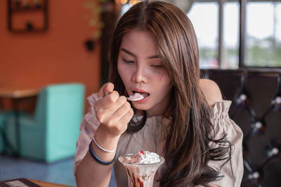 Young woman eating ice cream