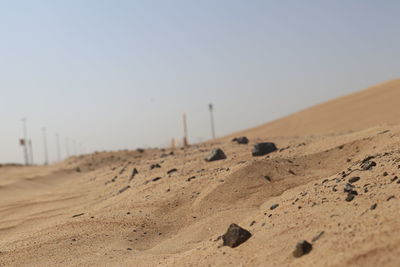 Sand dunes in desert against clear sky