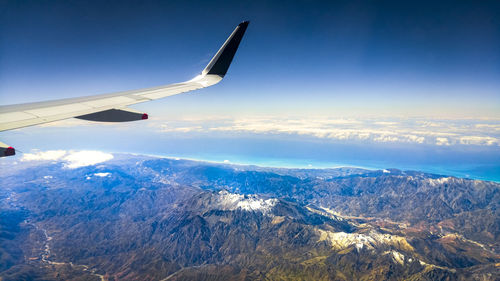 Aerial view of snowcapped mountains against sky