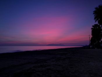 Scenic view of beach against sky during sunset