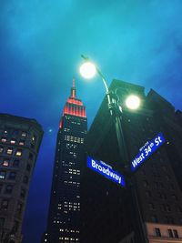 Low angle view of illuminated tower at night