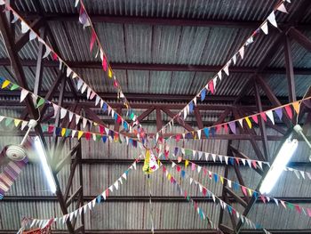 Low angle view of multi colored flags hanging on ceiling