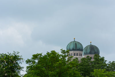 View of trees and building against sky