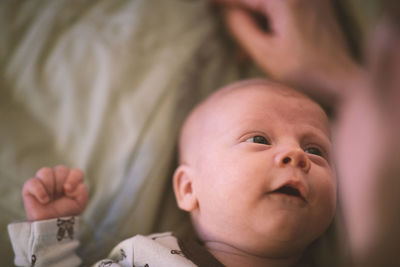 Portrait of cute baby lying on bed