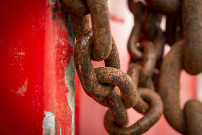 Close-up of rusty metal chain against wall