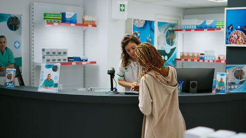 Side view of young woman with daughter at home