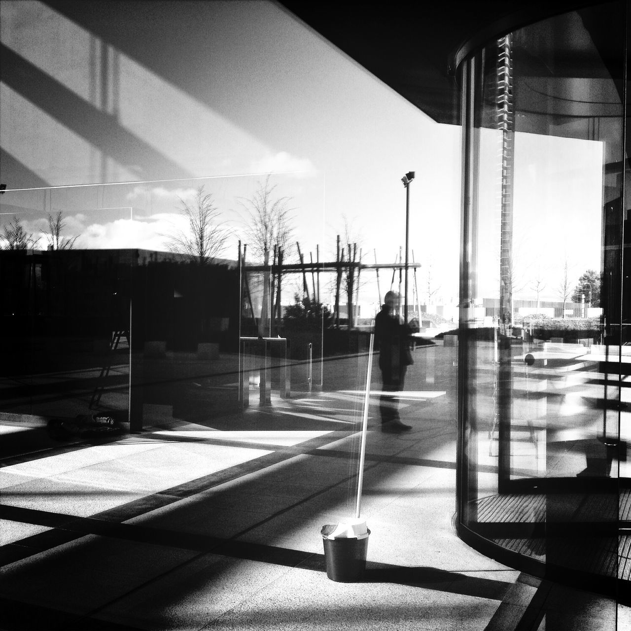 indoors, built structure, architecture, sunlight, glass - material, window, chair, silhouette, transparent, table, building exterior, shadow, sky, day, city, empty, reflection, incidental people, sitting