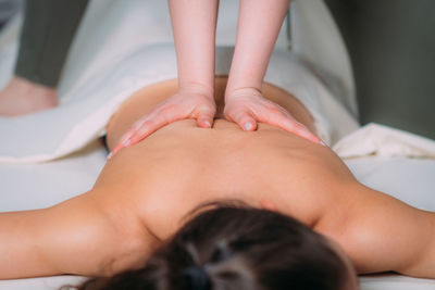 Back massage in a massage salon, woman having a relaxing back massage.