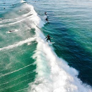 High angle view of men surfing in sea