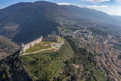 Aerial view of the city of assisi umbria with snow covered mount subasio