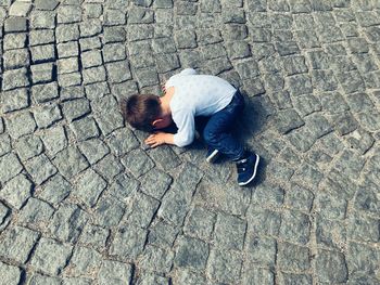 High angle view of lying on footpath