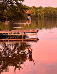 Rear view of woman standing in lake