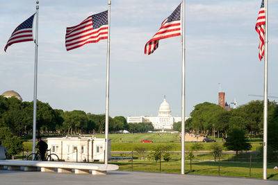 Low angle view, raw of american flags at washington monument, senate capitol and national mall 