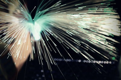 Low angle view of illuminated fireworks against sky at night