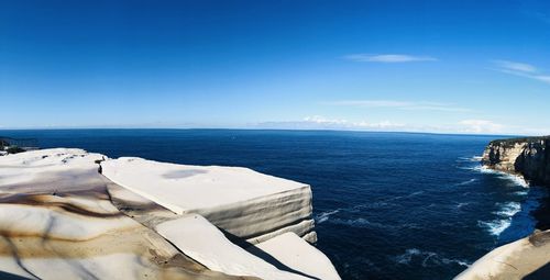 Scenic view of sea against blue sky