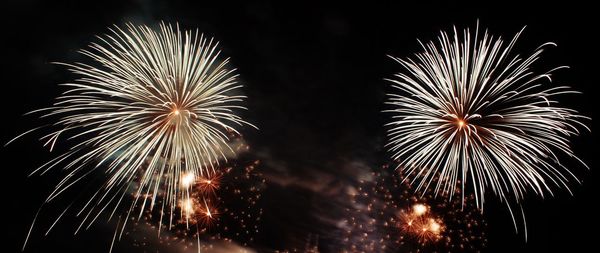 Low angle view of firework display at night