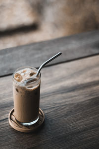 Close-up of glass iced milk coffee on table