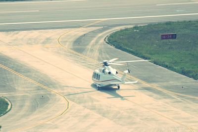 High angle view of airplane on airport runway