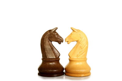 Close-up of chess pieces against white background