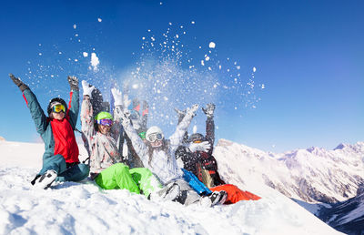 Low angle view of people on snow