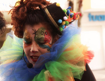 Close-up of mid adult woman in face paint standing outdoors