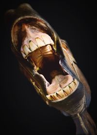 Close-up of human hand against black background