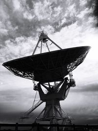 Low angle view of communications tower against sky