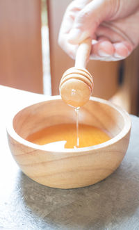 Close-up of hand pouring juice in bowl