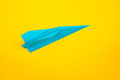 High angle view of paper flag on yellow background