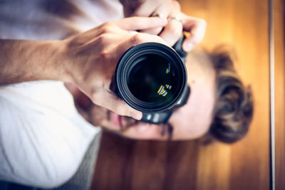 Cropped image of man photographing