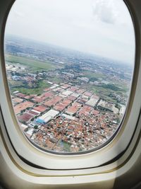 Aerial view of cityscape seen through airplane window