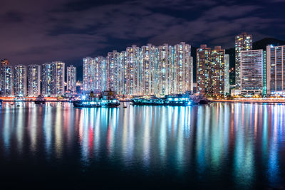 Illuminated buildings and water reflection in city at night 