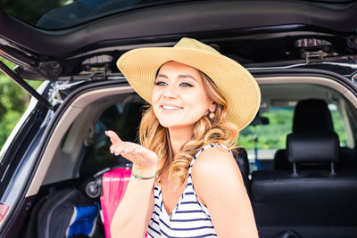 Portrait of smiling young woman in car