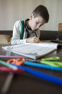 Boy sitting on table