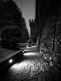 Walkway in city against sky