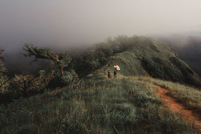 Scenic view of mountains against sky during foggy weather