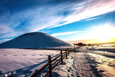 Scenic view of landscape against sky during winter