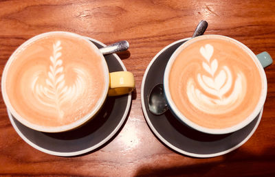 High angle view of cappuccino and coffee on table