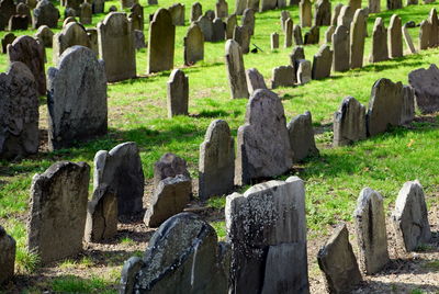 High angle view of tombstones on field in cemetery