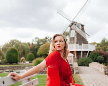 Portrait of woman standing against sky