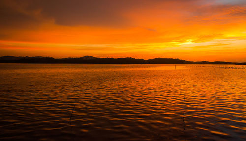 Scenic view of lake against sky during sunset