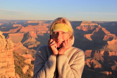 Portrait of woman standing against rocky mountains at grand canyon national park