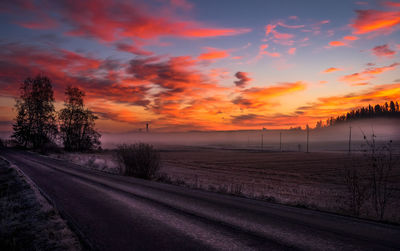 Scenic view of dramatic sky over landscape during sunset