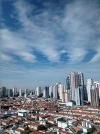 Cityscape against cloudy sky