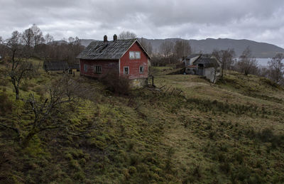 Houses on field against sky