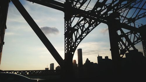 Low angle view of bridge against cloudy sky