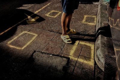 Low section of man walking on sidewalk